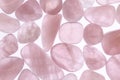 Rose quartz jewel heap texture on light surface. Royalty Free Stock Photo