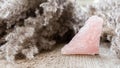 Rose quartz mineral specimen on wooden background