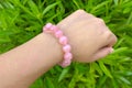 Rose quartz on a woman wrist. Royalty Free Stock Photo