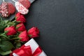 Rose red flowers, brownie cookies and chocolate candy on heart shaped, gift box with wine on black background. Valentines day, Royalty Free Stock Photo