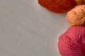 Rose, red and orange balls of yarn. Royalty Free Stock Photo