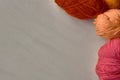 Rose, red and orange balls of yarn. Royalty Free Stock Photo