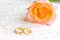 Rose, rings over handwritten letter