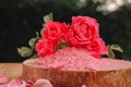 Rose salt.Pink salt, pink roses on a saw cut. Aromatherapy and cosmetics.rose flowers and pink cosmetics salt. cosmetics