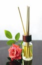 Rose scented oil bottle with wooden sticks Royalty Free Stock Photo