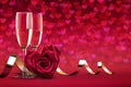 A rose in the shape of a heart, two glasses of champagne wine, a Valentine`s day or wedding card romantic concept of the red colo Royalty Free Stock Photo