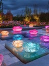 Rose-shaped path lights that are illuminated, lighting up a garden pathway in the dusk, created by generative ai Royalty Free Stock Photo
