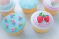 Rose and strawberry fondant cupcakes.