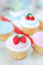 Rose and strawberry fondant cupcakes.