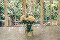A Rose vase on table in a glass house