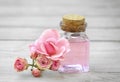 Rose water glass bottle decorated with flowers.Essential oil spa treatment. Aromatherapy. Beauty and skin care. Face cosmetics
