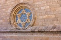 Rose window, gothic architecture with a shield over the stained glass.