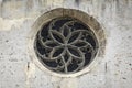 Rose window on the wall of Parochial Church in Fiera di Primiero. Royalty Free Stock Photo