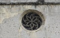 Rose window on the wall of Parochial Church in Fiera di Primiero. Royalty Free Stock Photo
