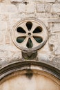 Rose window on the stone wall of the church. Close-up Royalty Free Stock Photo