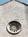 Rose window on the stone wall of an old church Royalty Free Stock Photo