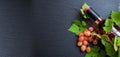 Rose wine bottle and fresh grapes on black background, copy space Royalty Free Stock Photo