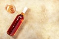 Rose wine glass with bottle on the beige table. Copy Space, top view Royalty Free Stock Photo