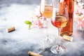 Rose wine glass with bottle on the gray table and pink flowers. Rosado, rosato or blush wine tasting in wineshop, bar concept. Royalty Free Stock Photo