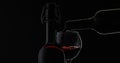 Rose wine. Red wine pour in wine glass over black background. Silhouette Royalty Free Stock Photo