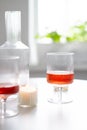 Rose wine in trendy ribbed wineglasses and decanter on white table Royalty Free Stock Photo