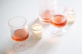 Rose wine in trendy ribbed wineglasses and decanter on white table Royalty Free Stock Photo