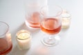 Rose wine in trendy ribbed wineglasses and decanter on white table Royalty Free Stock Photo