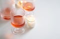 Rose wine in trendy ribbed wineglasses and decanter on white table Royalty Free Stock Photo