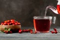 Rosehip glass cup of herbal tea medicinal plants with rosehip fruits pouring glass teapot on table