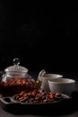 Rosehip tea. Vitamin drink. A teapot and cups of freshly brewed vitamin rose hips, a dark mood. Copy space