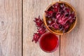 Roselle fruit  Jamaica sorrel, Rozelle or hibiscus sabdariffa  and glass of roselle juice tea isolated on wooden table backgroun Royalty Free Stock Photo