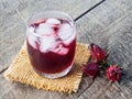 Roselle juice and ice in glass on sack