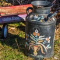 Rosemaling on an Antique Milk Can and Radio Flyer Wagon Royalty Free Stock Photo