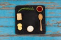 Rosemary, cheese and biscuits with spices on slate board Royalty Free Stock Photo