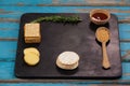 Rosemary, cheese and biscuits with spices on slate board Royalty Free Stock Photo