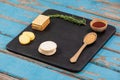 Rosemary, cheese and biscuits with spices on slate board Royalty Free Stock Photo