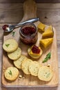 Rosemary crackers on cheese board with relish