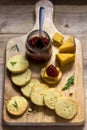 Rosemary crackers on cheese board with relish