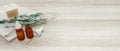 Rosemary essential oil and fresh twig on wooden background. 3d rendering