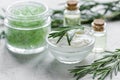 Rosemary essential oil in glass bottle in cosmetic set on table background Royalty Free Stock Photo