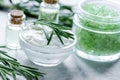Rosemary essential oil in glass bottle in cosmetic set on table Royalty Free Stock Photo