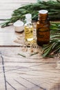 Rosemary essential oil in a glass bottle with fresh branch rosemary herb on wooden table for spa,aromatherapy and bodycare.Copy Royalty Free Stock Photo