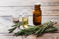 Rosemary essential oil in a glass bottle with fresh branch rosemary herb on wooden table for spa,aromatherapy and bodycare.Copy Royalty Free Stock Photo