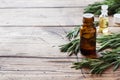 Rosemary essential oil in a glass bottle with fresh branch rosemary herb on wooden table for spa,aromatherapy and bodycare.Copy Royalty Free Stock Photo