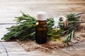 Rosemary essential oil in a glass bottle with fresh branch rosemary herb on wooden table for spa,aromatherapy and bodycare.Copy Royalty Free Stock Photo