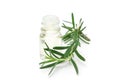 Rosemary essential oil in glass and fresh rosemary twig isolated Royalty Free Stock Photo