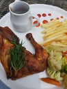 Rosemary grilled chicken with french fries, vegetables and black pepper sauce