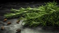 Rosemary spice is lying on dark table. Fresh twigs green spice ready for use. Close-up.