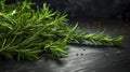 Rosemary spice is lying on dark table. Fresh ÃÂµwigs green spice ready for use. Close-up.