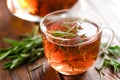 Rosemary tea in glass tea cup on rustic wooden table closeup. Herbal vitamin tea Royalty Free Stock Photo